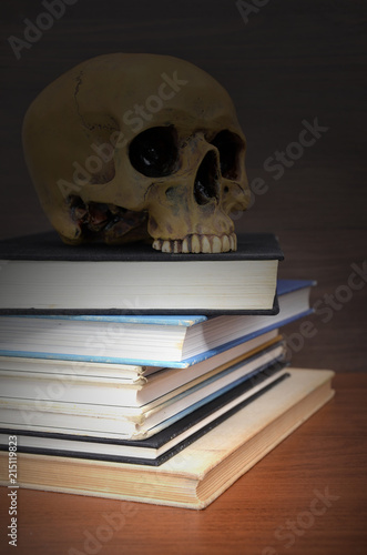 books with a human skull in the dark