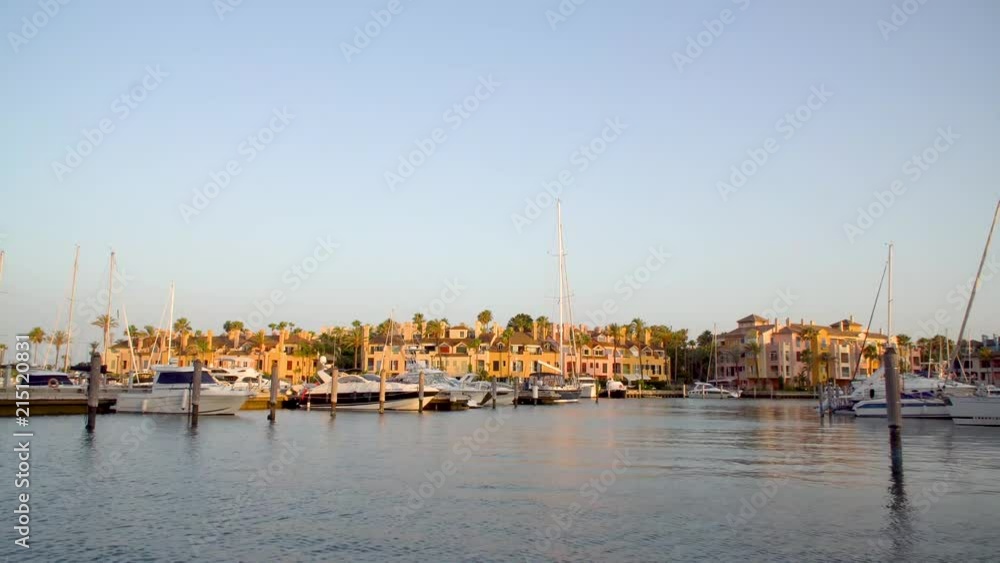 Golden hour at the marina of Sotogrande. A luxurious place to live ar go on vacations if you have a big yacht. Very luxorious location where you can see amazing yachts, colorfull houses and nice cars. Golden hour at the marina of Sotogrande. A luxurious place to live ar go on vacations if you have a big yacht. Very luxorious location where you can see amazing yachts, colorfull houses and nice cars.