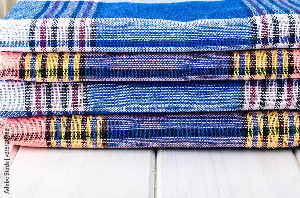 Stack of towels in cage on white wooden table Stack of towels in cage on white wooden table