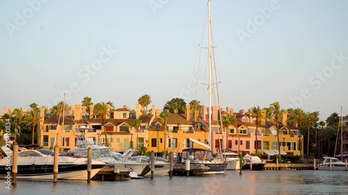 Golden hour at the marina of Sotogrande. A luxurious place to live ar go on vacations if you have a big yacht. Very luxorious location where you can see amazing yachts, colorfull houses and nice cars. photo