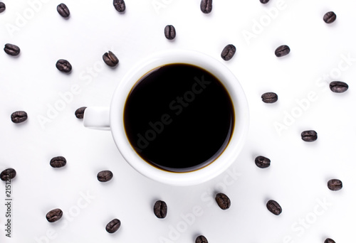 Black coffee in white cup with many coffee beans isolated on white background.