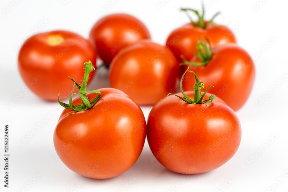 Red tomatoes on a white table. Tasty vegetables for the best dishes in the kitchen. Red tomatoes on a white table. Tasty vegetables for the best dishes in the kitchen.