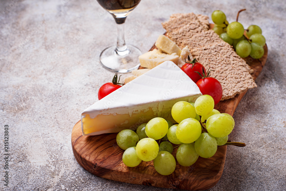 Cheese plate with brie, grape and wine Cheese plate with brie, grape and wine
