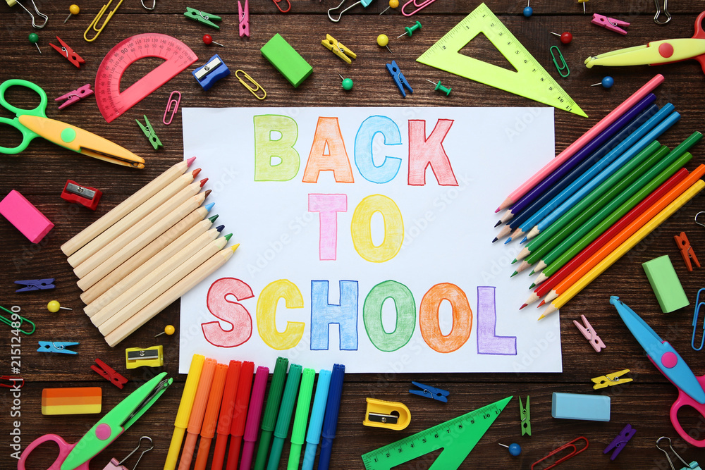 Inscriptions Back To School with school supplies on wooden table Inscriptions Back To School with school supplies on wooden table