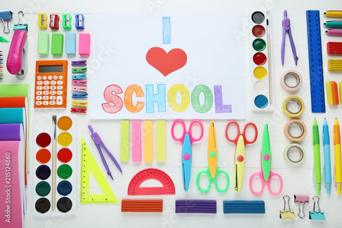 Inscription I Love School with school supplies on wooden table