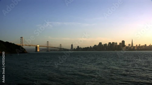 Timelapse day to night of bay with Golden Gate Bridge and crescent moon San Francisco California