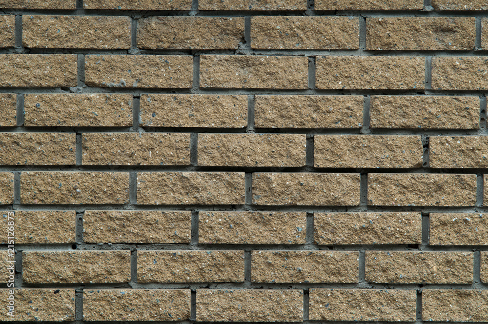 Obraz premium Dark sand rough brick wall.