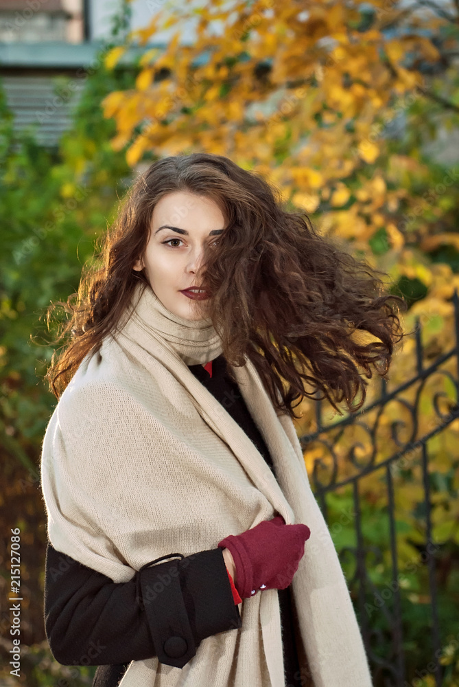 woman in a coat walks in autumn park woman in a coat walks in autumn park