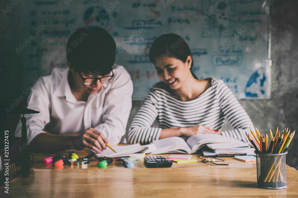 Fototapeta premium High school or college Asian student group sitting at desk in class studying and reading, doing homework and lesson practice preparing exam to entrance, education concept