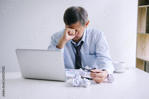 Feeling sick and tired, Senior businessman depressed and exhausted, businessman at his desk frustrated with problems and keeping eyes closed while sitting on office