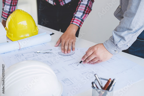 Architect or Engineer meeting working with partner on blueprint for architectural project in progress, construction and structure concept