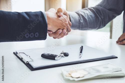 Фотография Handshake of cooperation customer and salesman after agreement, successful car l