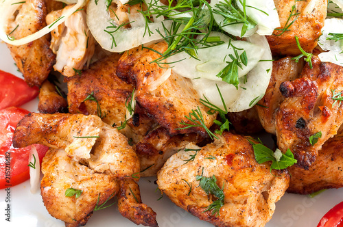 Fried skewers on the grill in a white dish