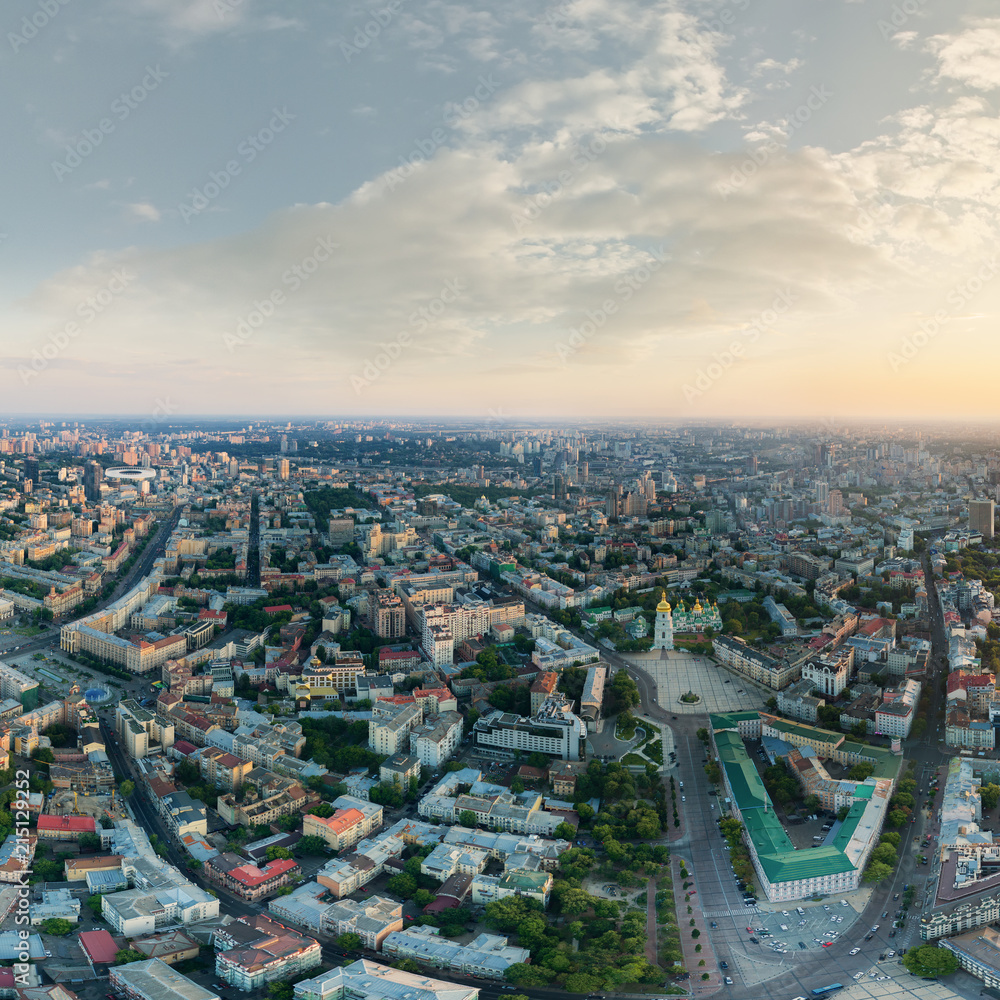 Panorama of the city of Kiev at sunset. A modern metropolis in the center of Europe against the backdrop of sunset sky from a bird's eye view. Aerial view. Panorama of the Tourist Center of Kiev.