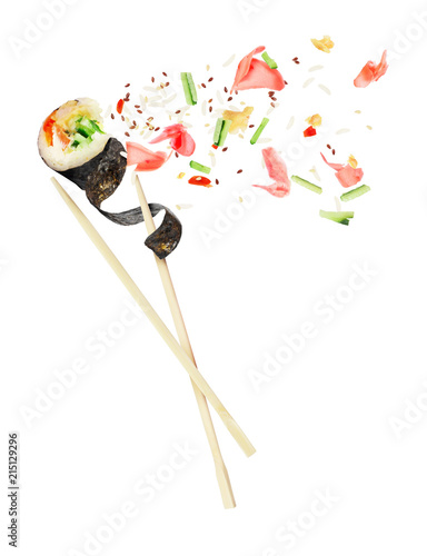 Unfolded sushi roll is sandwiched between of wooden chopsticks, isolated on white background