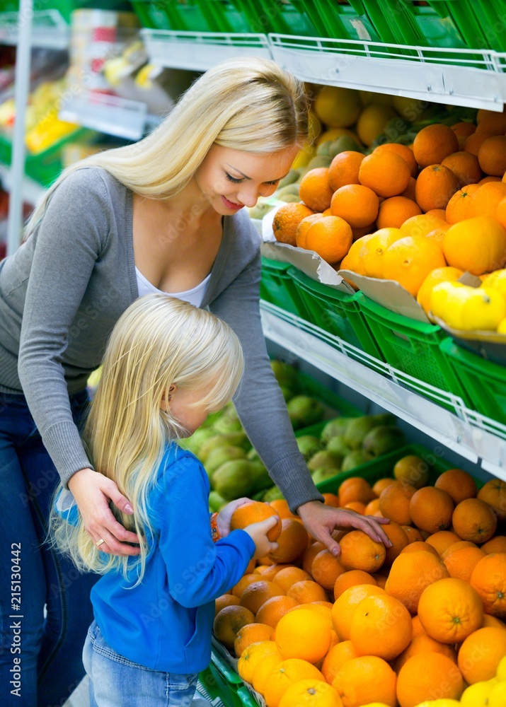 Mother and Daughter Shopping in Supermarket