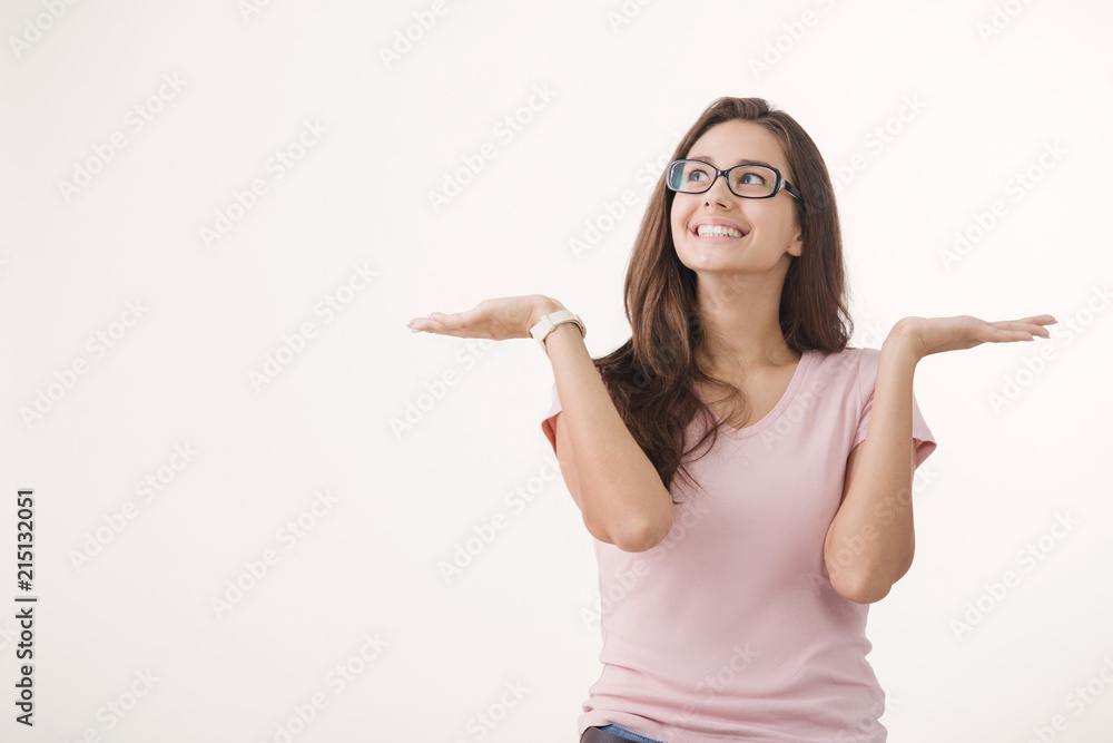 Portrait of young cheerful brown-haired woman wearing glasses against white background Portrait of young cheerful brown-haired woman wearing glasses against white background