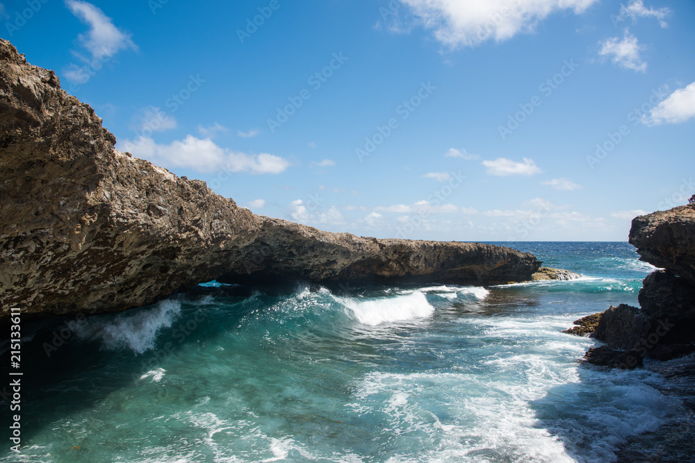 Naklejka premium Waves coming through Natural Bridge at Shete Boka natural park, Curacao