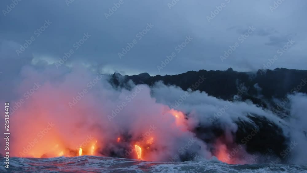 Molten Lava Streams from Hawaii's Kilauea Volcano Into the Ocean At Dawn Molten Lava Streams from Hawaii's Kilauea Volcano Into the Ocean At Dawn