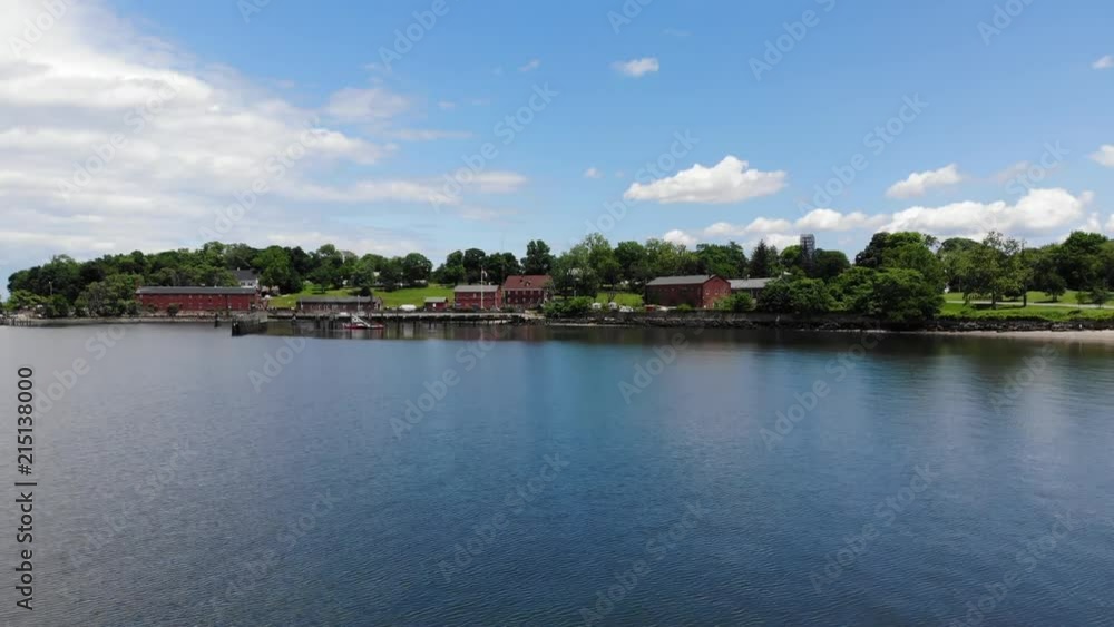Flying Over Lake with Buildings in the Distance Flying Over Lake with Buildings in the Distance