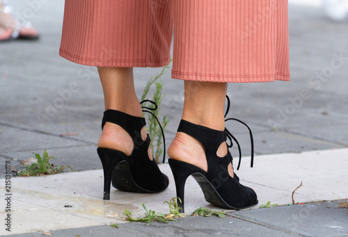 closeup of woman feet in black leather high heel