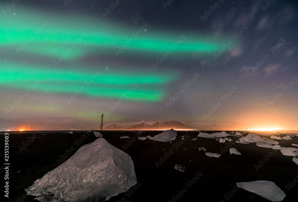 Northern lights on the Diamond beach in south east Iceland, Jokursarlon Vik ice rocks ocean