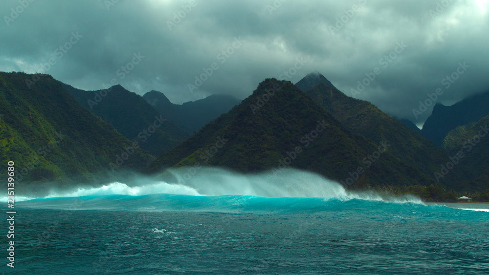 Powerful offshore wind creating large breaking waves near the exotic island.