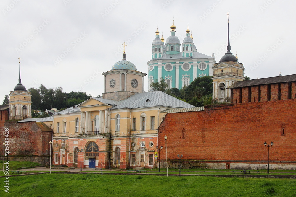 Russia - the Smolensk fortress wall and the Church of Hodegetria on the background of the Uspensky Cathedral in the summer cloudy day Russia - the Smolensk fortress wall and the Church of Hodegetria on the background of the Uspensky Cathedral in the summer cloudy day