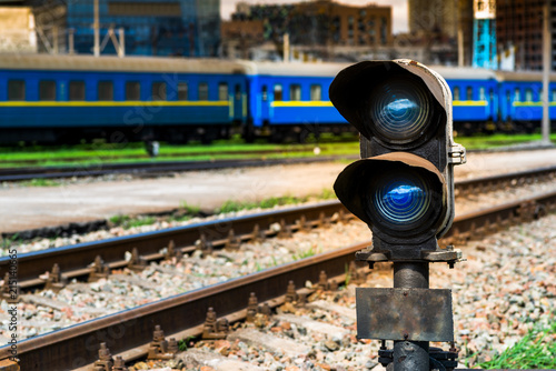 blue signal of the semaphore on the background of the railway track photo