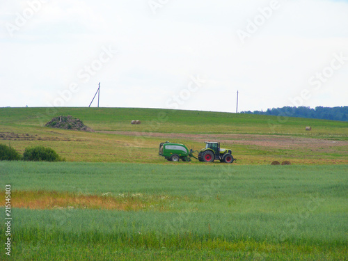 Tractor on farm landscape, agriculture farming concept.