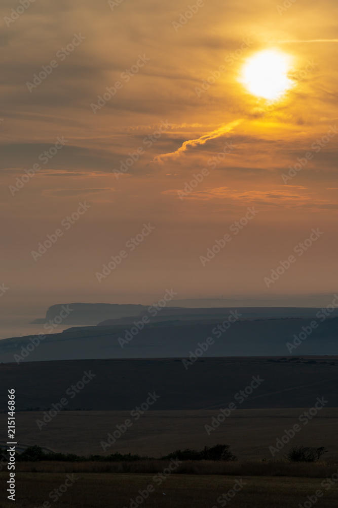 Looking out over the countryside and coastline in Sussex, at sunset