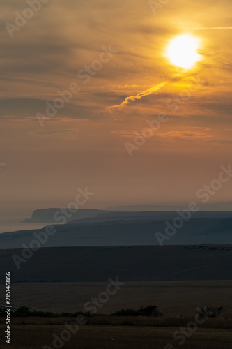 Looking out over the countryside and coastline in Sussex, at sunset
