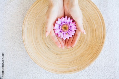 Spa Treatments. Woman Hold Beautiful Flower in Her Hands