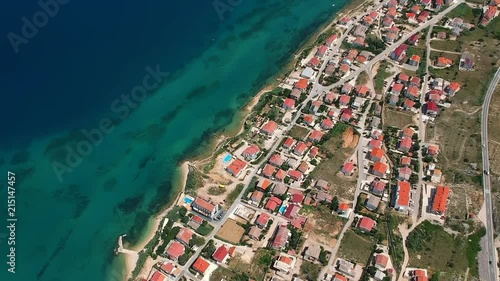 Revealing shot of tourist houses and hotels with a beautiful beach and blue sea