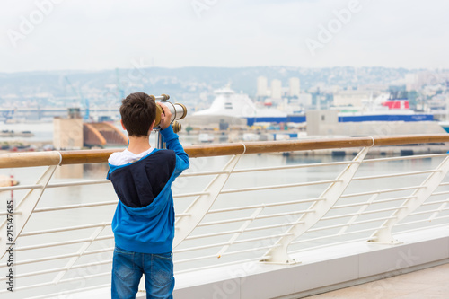 Young boy exploring the Port with a telescope