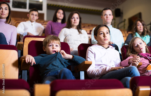 People enjoying film screening in cinema