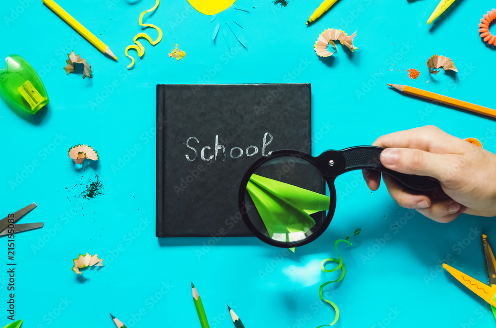 school. knowledge. In the hand, the magnifying glass enlarged the paper