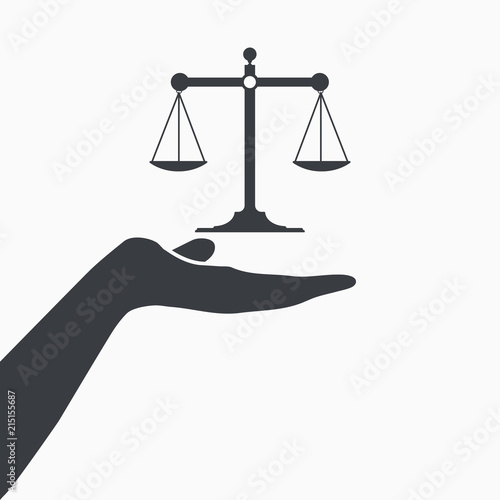 Hand holding to scale to weigh objects in balance
