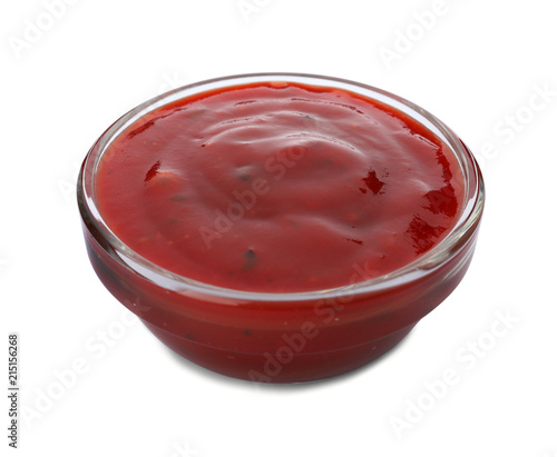 Bowl of spicy chili sauce on white background