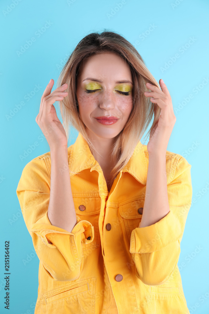 Beautiful young woman posing on color background. Summer fashion Beautiful young woman posing on color background. Summer fashion