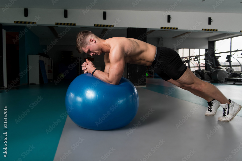 Young Man Doing Abdominal Exercise On Ball