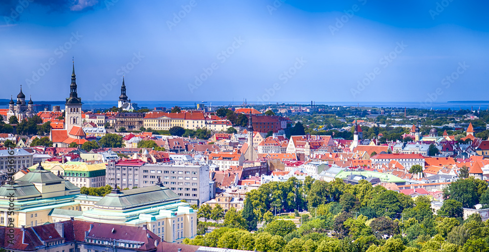 Cityscape View of Tallinn City on Toompea Hill in Estonia. Shot Covers Lines of Traditional Red Roofs of Medieval Houses, Towers, Cathedral and Churches. Bay on the Foreground.