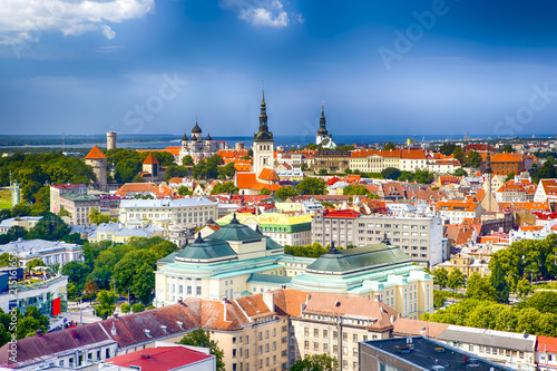 Panoramic Cityscape View of Tallinn City on Toompea Hill in Estonia. Shot Covers Lines of Traditional Red Roofs of Medieval Houses, Towers, Cathedral and Churches with Port partial View.