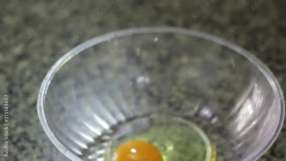 A Women Cooking on a Chef White Coat Breaking Eggs A Women Cooking on a Chef White Coat Breaking Eggs