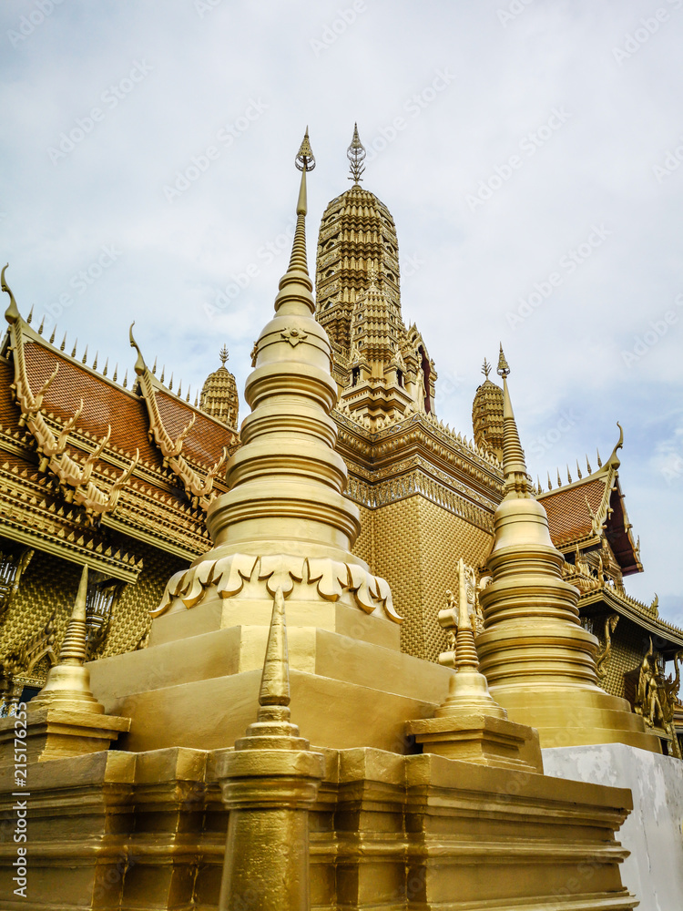 Fototapeta premium Golden buddhist temple with stupa, replica of an ancient thai temple in Ancient City at Muang Boran in Thailand, Buddhavas of the Substanceless Universe