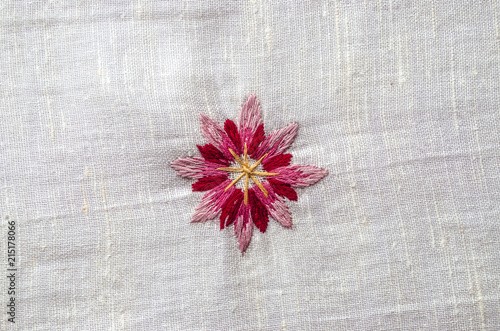 Embroidered satin seam, melange threads,red pink flower cornflower on coarse cotton fabric
