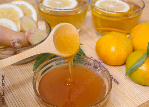 Still life. Tea in transparent cups. Honey, ginger, lemon and tangerines. From cold and flu.