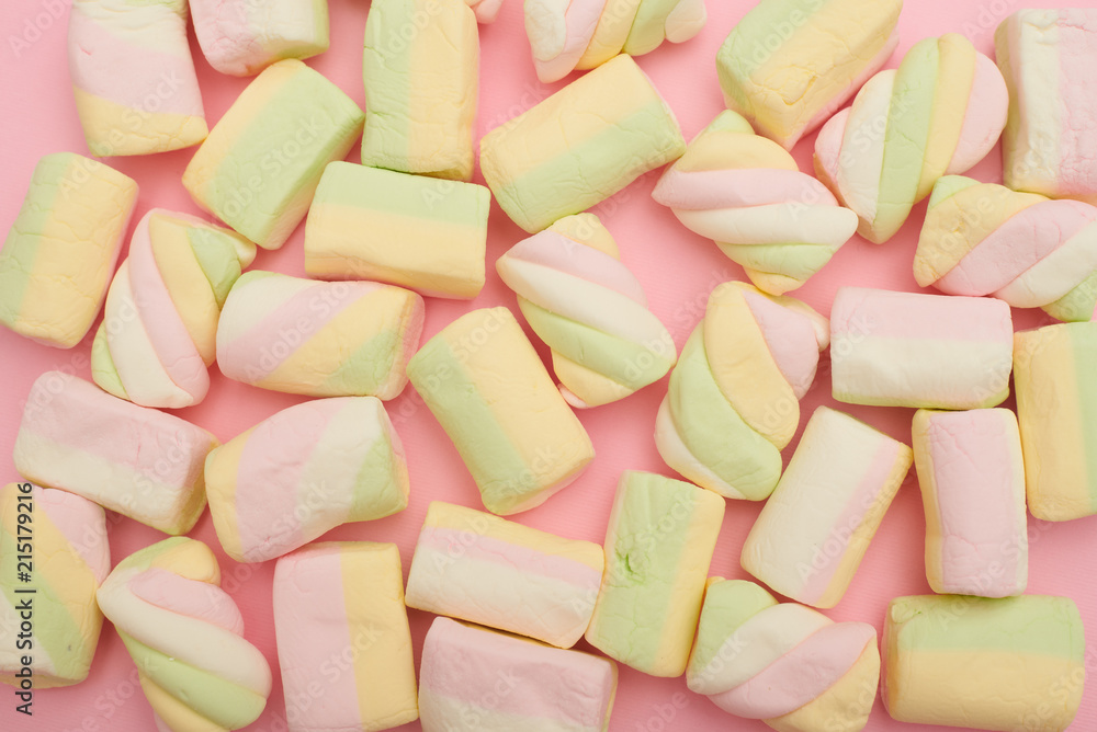Colorful marshmallows placing on pink flatlay Colorful marshmallows placing on pink flatlay