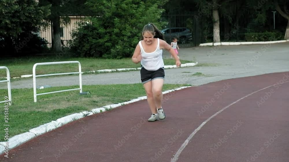 Little fat girl runs in the stadium Little fat girl runs in the stadium