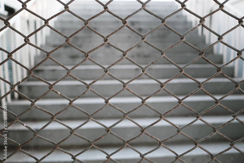 Chain link fence in front of stairway Chain link fence in front of stairway